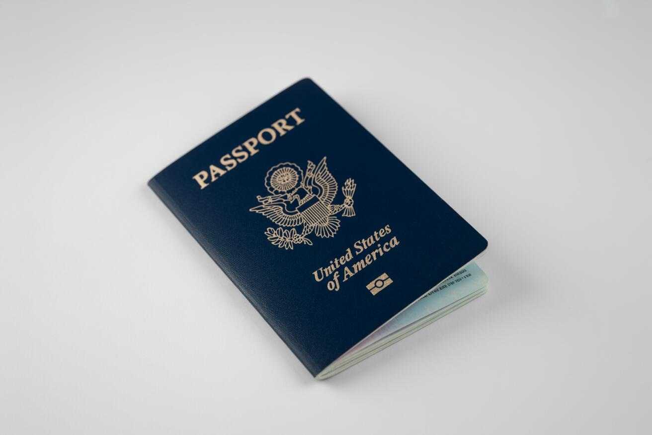 A United States passport lying on a white table